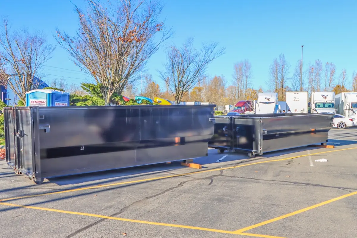 Professional dumpster rental service with roll-off container on residential driveway in Halawa